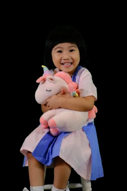 Female student hugging her stuff toy
